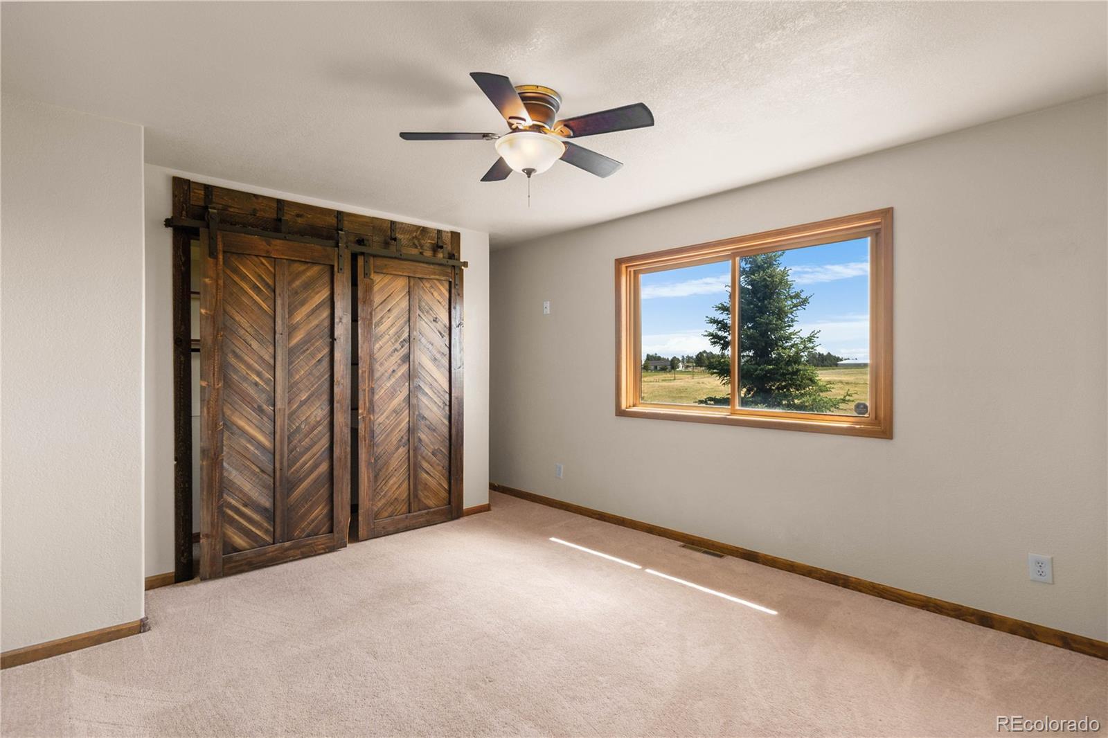 74 Rocky Cliff Road Elizabeth, CO 80107 - Photo 27 of 50 an empty room with window and ceiling fan