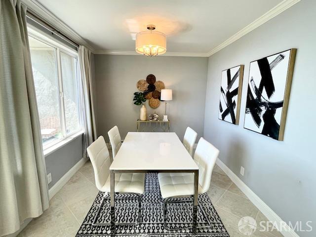 5007 Palmetto Avenue, Unit 37 Pacifica, CA 94044 - Photo 3 of 9 a room with a table chairs and a chandelier