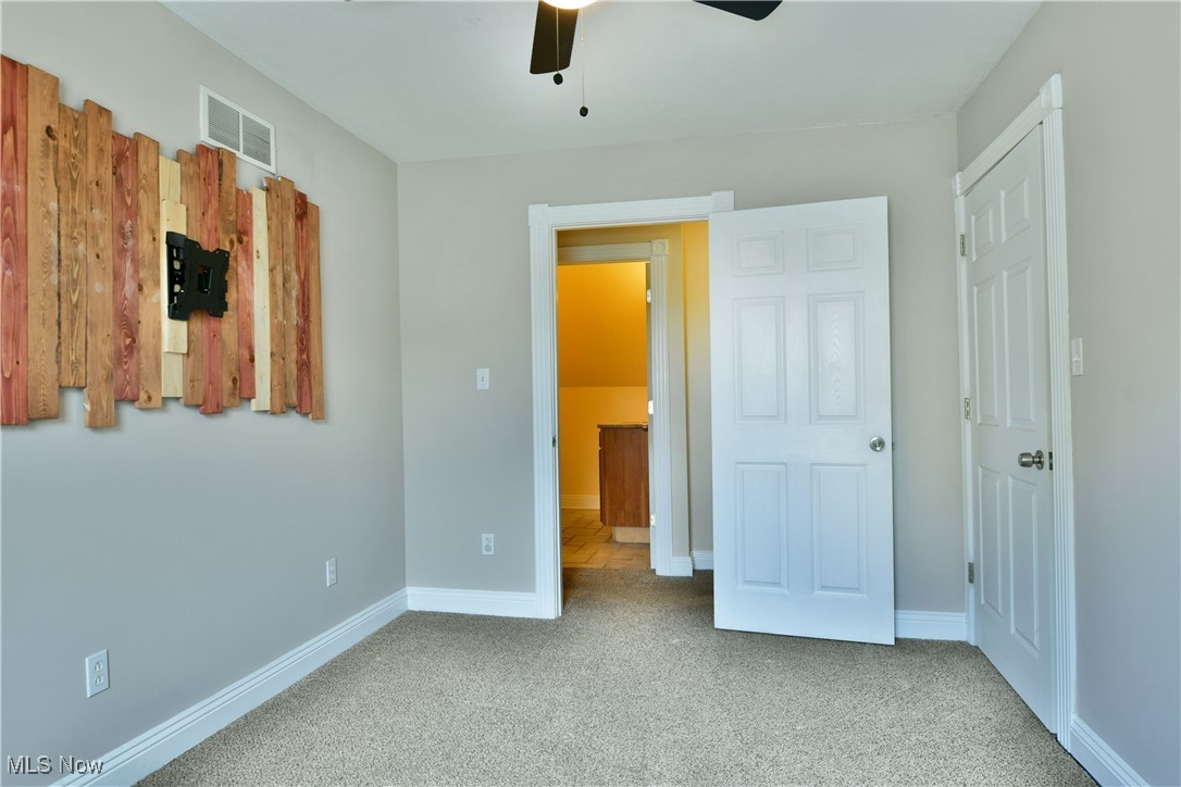 1735 Pleasant Valley Road Girard, OH 44420 - Photo 28 of 44 Unfurnished bedroom with carpet flooring, baseboards, and a ceiling fan