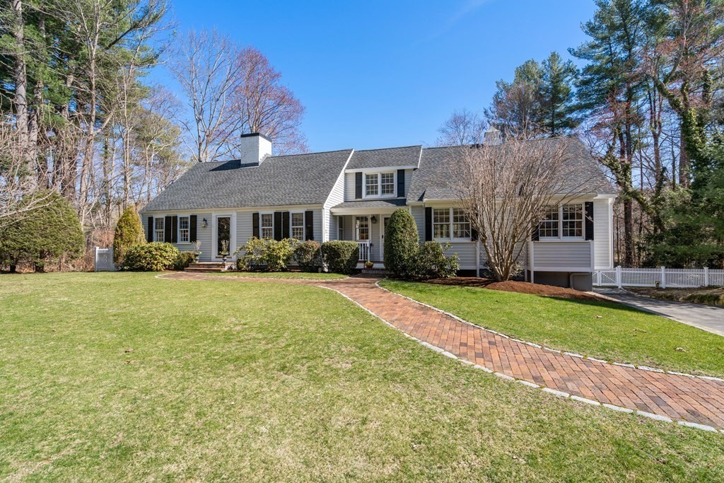 48 Brook Road Weston, MA 02493 - Photo 1 of 32 a front view of a house with a yard table and chairs