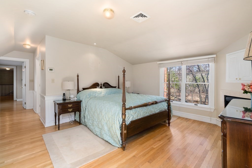 48 Brook Road Weston, MA 02493 - Photo 20 of 32 a bedroom with a bed and wooden floor