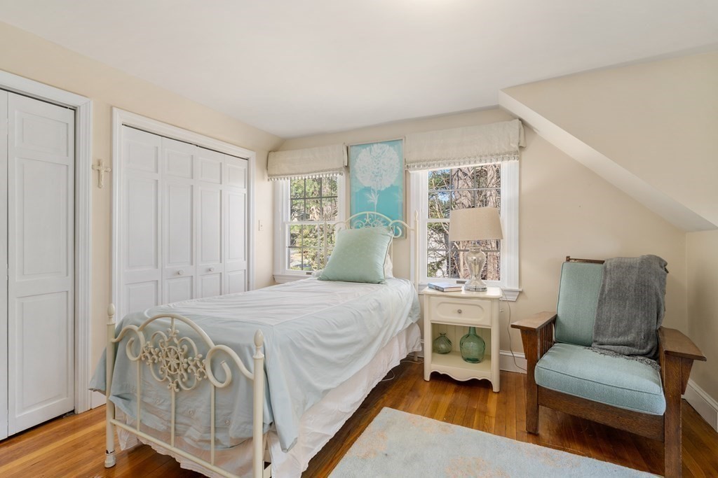 48 Brook Road Weston, MA 02493 - Photo 23 of 32 a bedroom with a bed table and a window