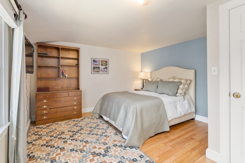 48 Brook Road Weston, MA 02493 - Photo 26 of 32 a bedroom with a bed and a cabinets