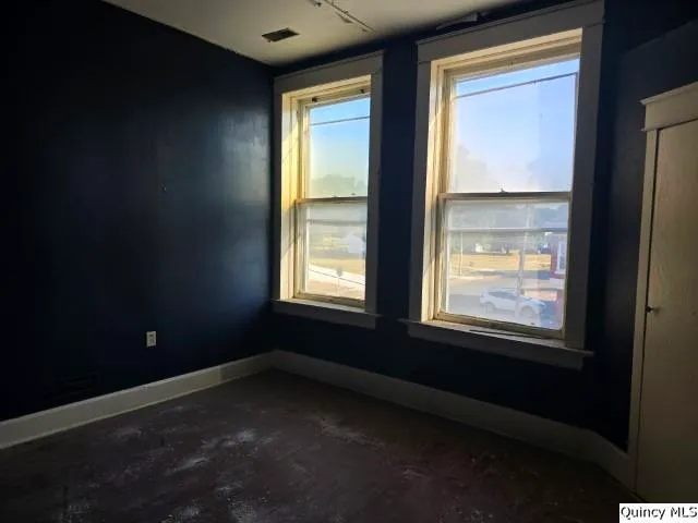 an empty room with closet and mirror