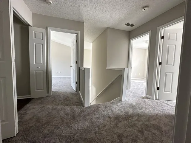 an empty room with closet and a bathroom