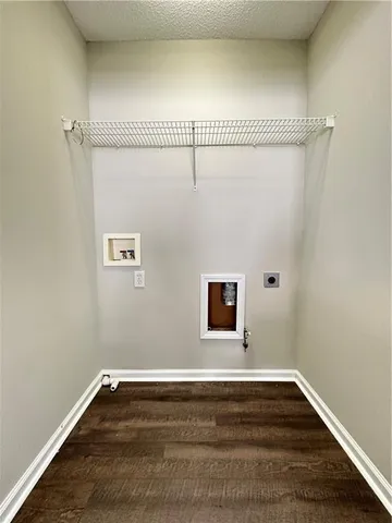 a view of a room with wooden floor and window