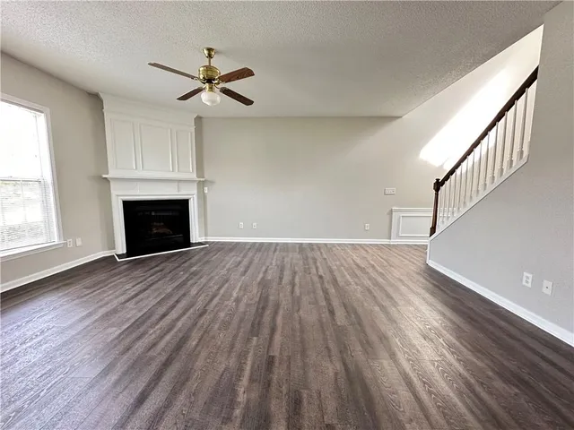 wooden floor in an empty room with a fireplace