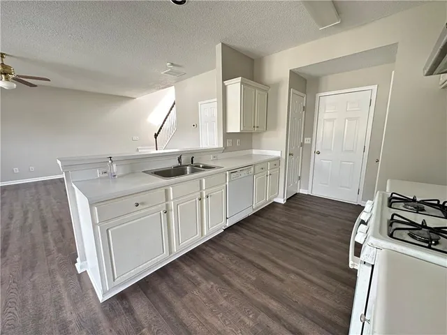 a kitchen with a sink stove and cabinets