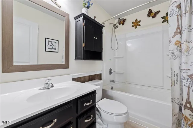 a kitchen with stainless steel appliances granite countertop a refrigerator a sink dishwasher a stove and a dining table with wooden floor