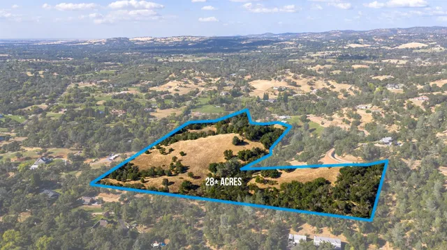 an aerial view of residential houses with city view
