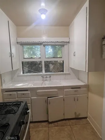 a kitchen with a stove and a sink