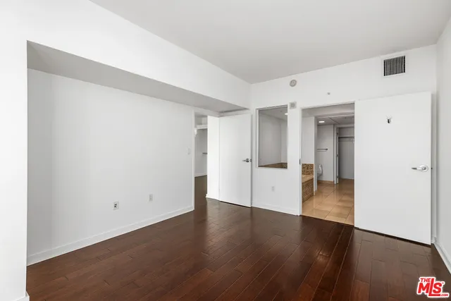 a bathroom with a granite countertop sink a mirror and a shower