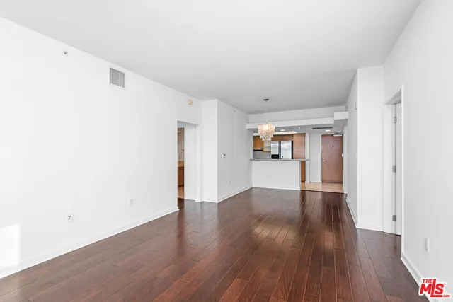 a kitchen with granite countertop a sink and refrigerator