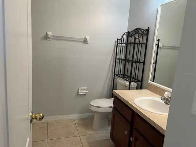 a bathroom with a sink toilet and mirror
