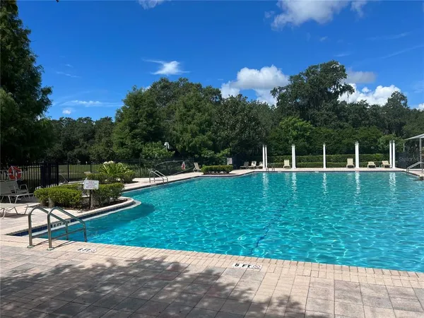 a view of a swimming pool with a yard