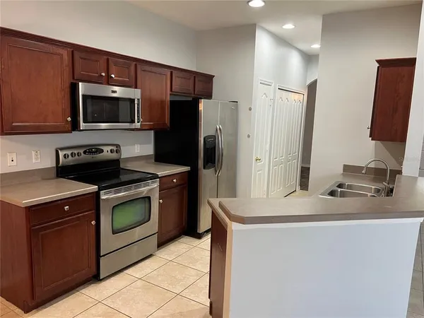 a kitchen with a sink stove and refrigerator