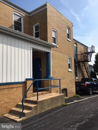a view of a building with car parked