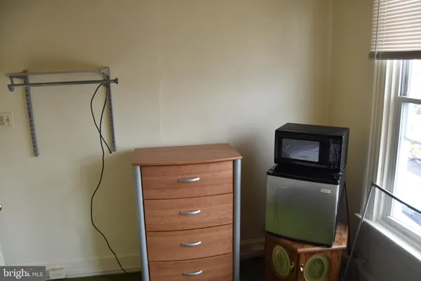 a room with a walk in closet a mirror and a window