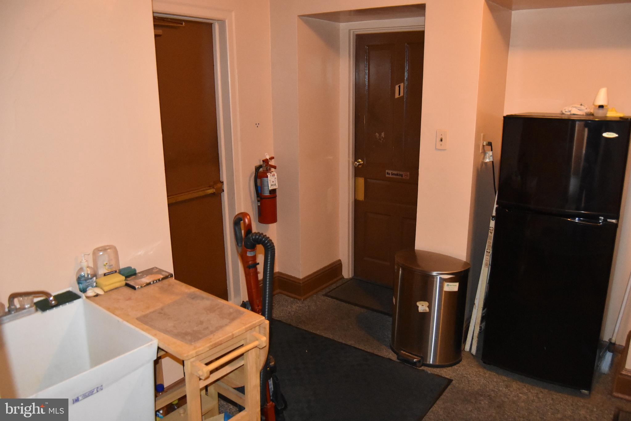 1241 North George Street York, PA 17404 - Photo 6 of 7 a room with a table and a refrigerator