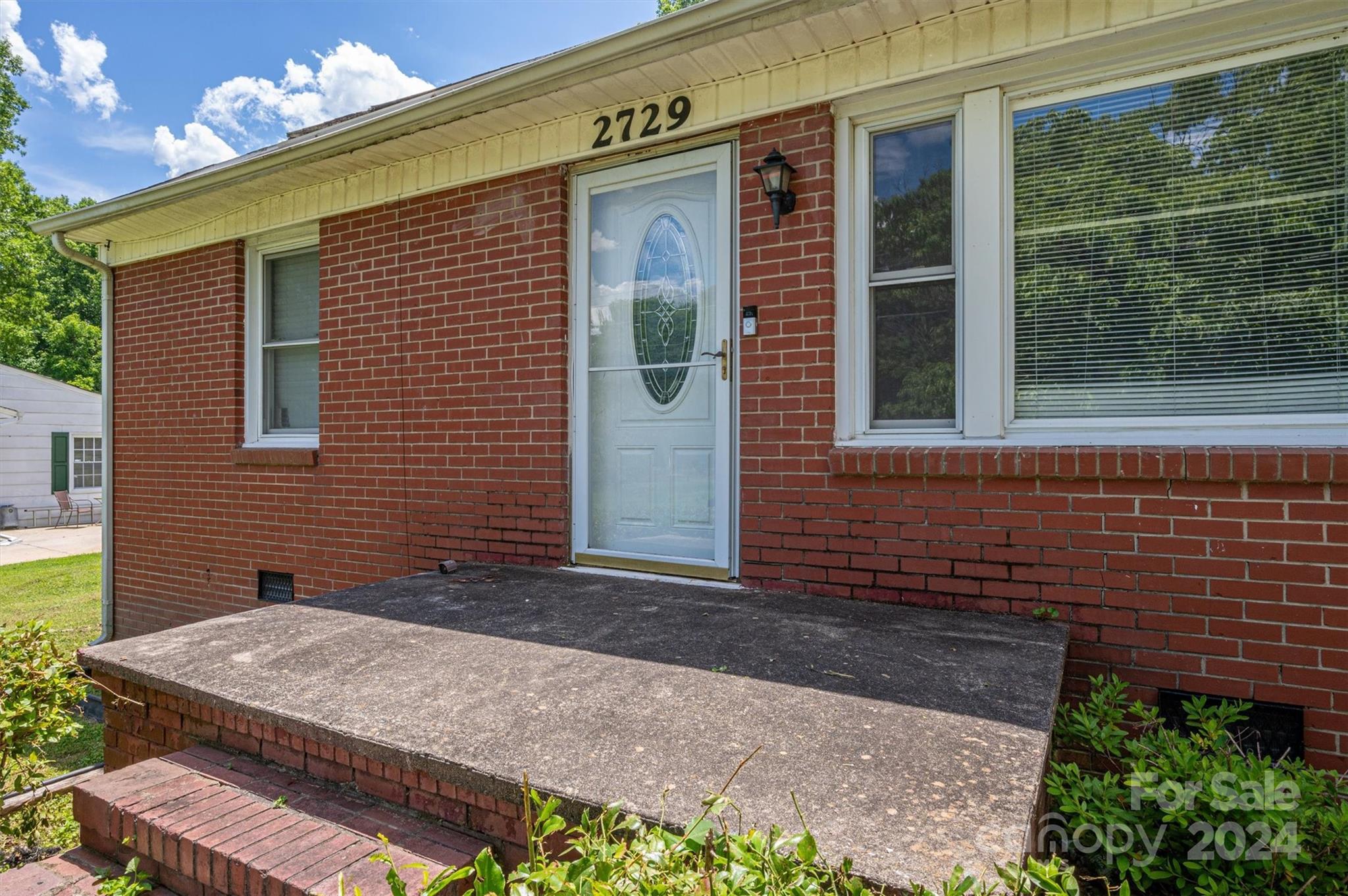 2729 Springbrook Circle Gastonia, NC 28052 - Photo 6 of 34 a front view of a house with a yard