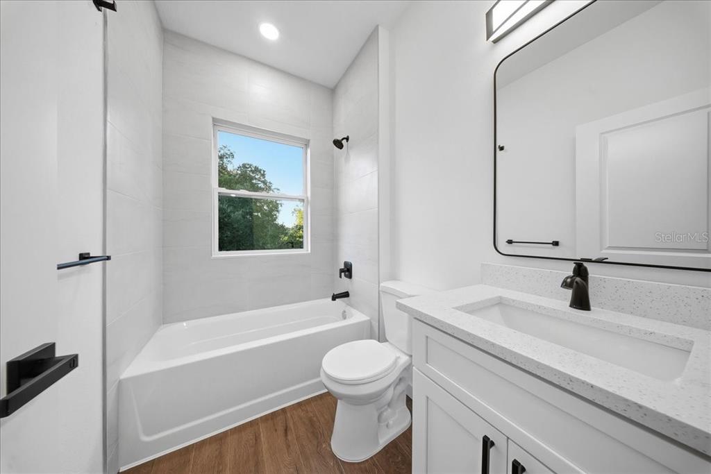 6464 Ohio Rd Port North Port, FL 34291 - Photo 20 of 35 a bathroom with a sink a toilet and a bathtub