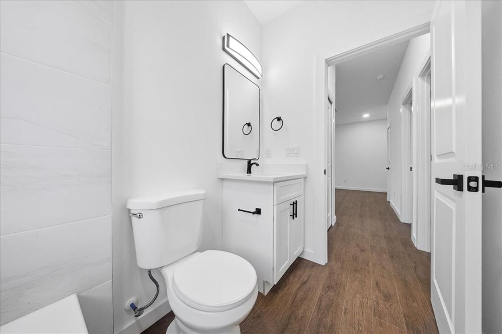 6464 Ohio Rd Port North Port, FL 34291 - Photo 21 of 35 a bathroom with a toilet a sink and mirror