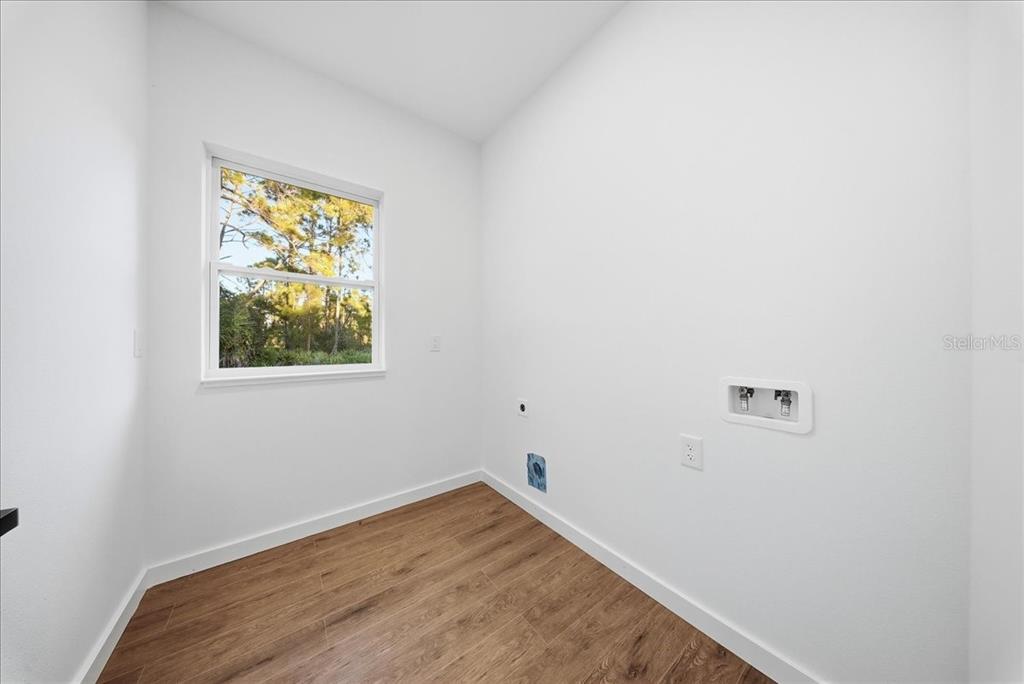 6464 Ohio Rd Port North Port, FL 34291 - Photo 25 of 35 a view of a small space with wooden floor and a window