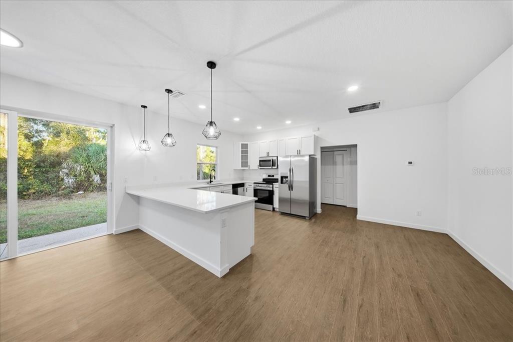 6464 Ohio Rd Port North Port, FL 34291 - Photo 5 of 35 a view of kitchen with furniture and large window