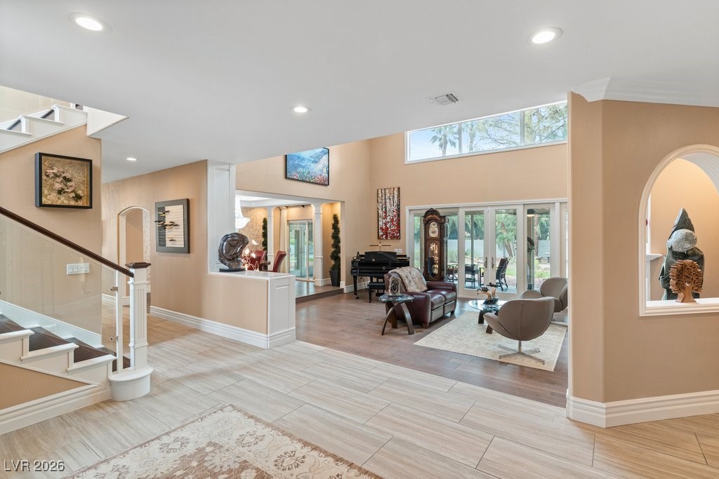 7 Larkside Court Henderson, NV 89014 - Photo 2 of 70 Foyer with stairs, wood tiled floors, recessed lighting, french doors, and arched walkways