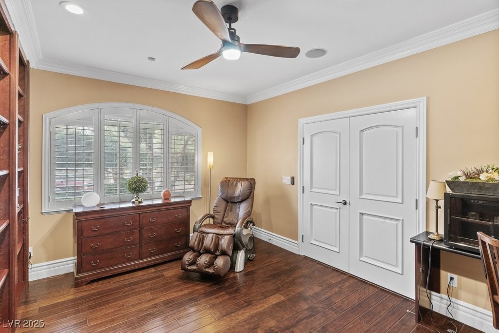 7 Larkside Court Henderson, NV 89014 - Photo 24 of 70 Living area featuring dark wood finished floors, ornamental molding, and ceiling fan