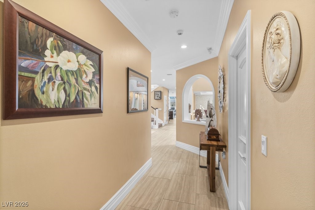 7 Larkside Court Henderson, NV 89014 - Photo 26 of 70 Corridor featuring crown molding, arched walkways, and recessed lighting