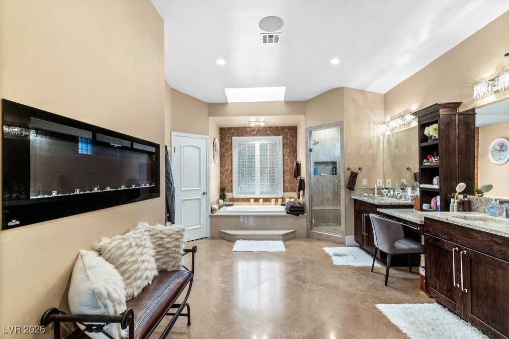 7 Larkside Court Henderson, NV 89014 - Photo 31 of 70 Bathroom with a garden tub, a shower stall, two vanities, and recessed lighting