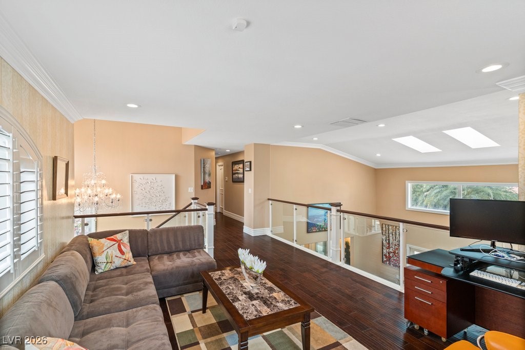 7 Larkside Court Henderson, NV 89014 - Photo 36 of 70 Living area featuring a chandelier, crown molding, dark wood-style floors, vaulted ceiling, and recessed lighting