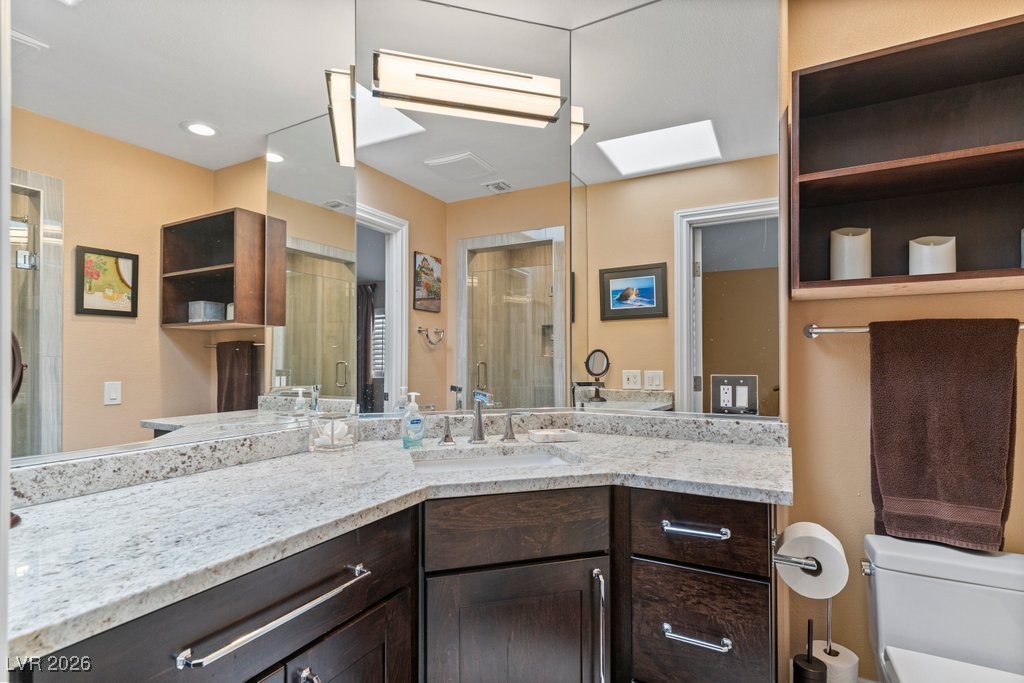 7 Larkside Court Henderson, NV 89014 - Photo 46 of 70 Full bath with a shower stall, vanity, and a skylight