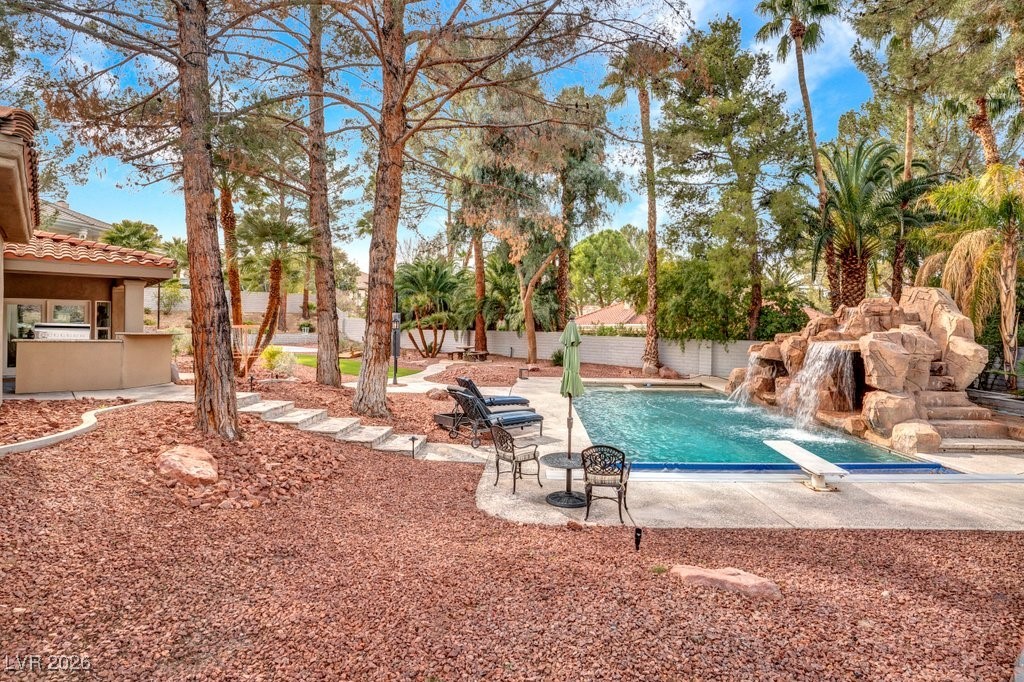 7 Larkside Court Henderson, NV 89014 - Photo 52 of 70 View of pool featuring a patio, a fenced backyard, and a water slide