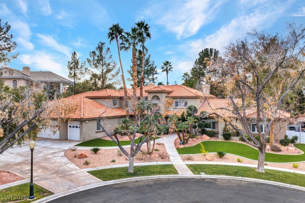 7 Larkside Court Henderson, NV 89014 - Photo 67 of 70 Mediterranean / spanish-style home featuring stucco siding, driveway, a front yard, and a tiled roof