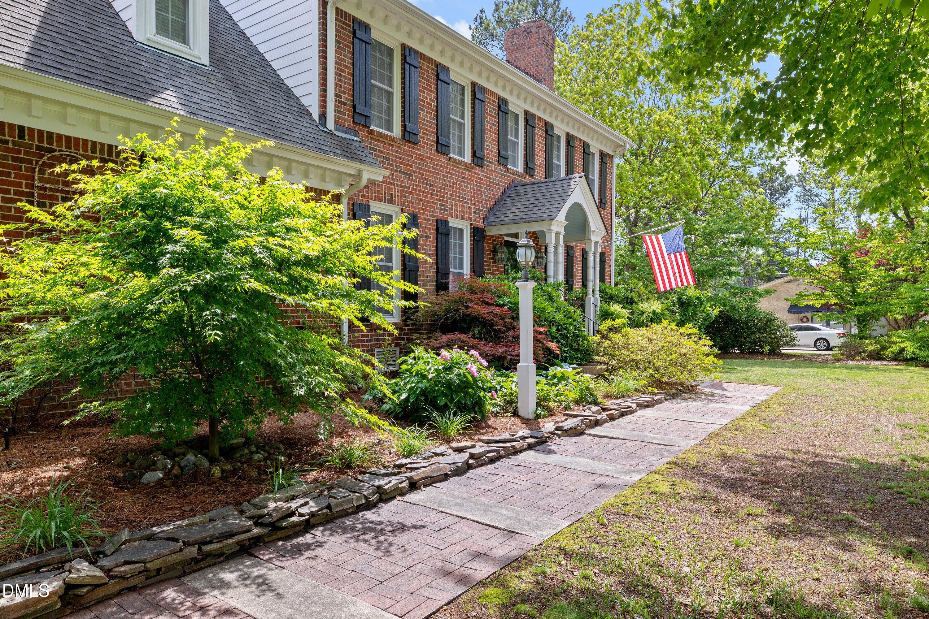 6612 Fowler Road Zebulon, NC 27597 - Photo 6 of 42 a front view of a house with a yard and a garden