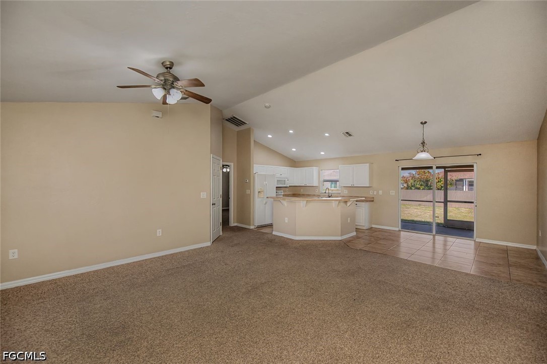4104 13th Street Southwest Lehigh Acres, FL 33976 - Photo 14 of 46 a view of a kitchen with a sink a ceiling fan and refrigerator