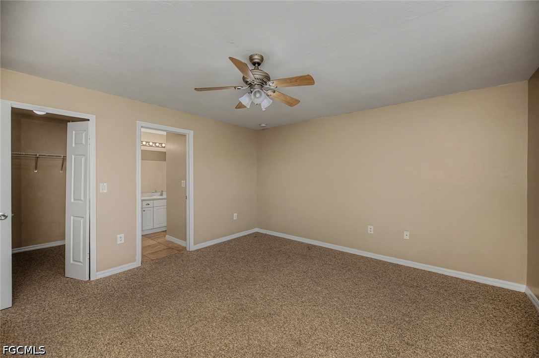 4104 13th Street Southwest Lehigh Acres, FL 33976 - Photo 18 of 46 an empty room with closet and a chandelier fan