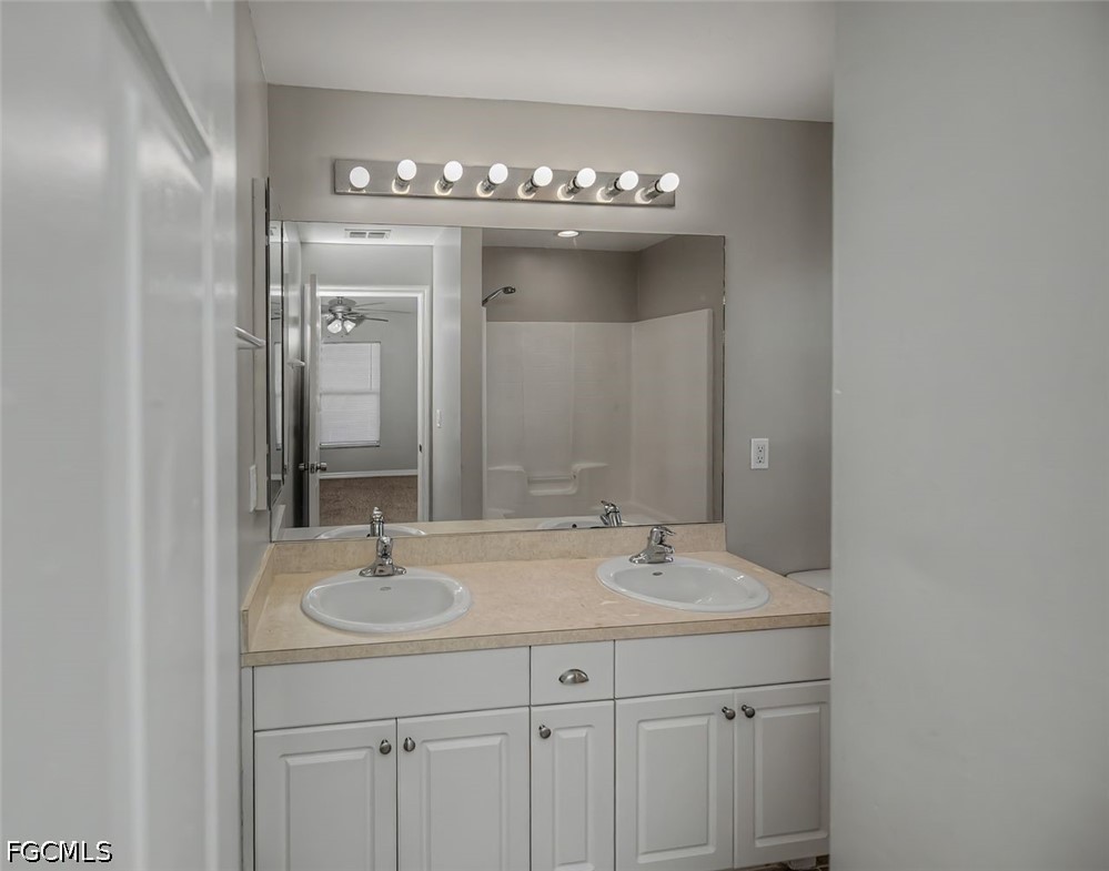 4104 13th Street Southwest Lehigh Acres, FL 33976 - Photo 19 of 46 a bathroom with a sink double vanity and a mirror