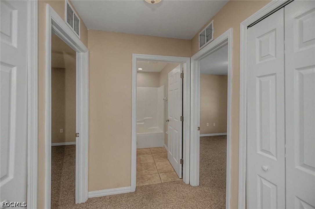 4104 13th Street Southwest Lehigh Acres, FL 33976 - Photo 22 of 46 a view of a hallway to other door