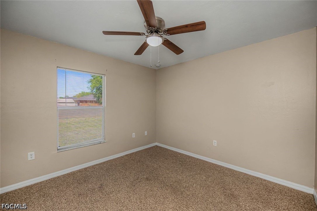 4104 13th Street Southwest Lehigh Acres, FL 33976 - Photo 23 of 46 an empty room with closet and ceiling fan