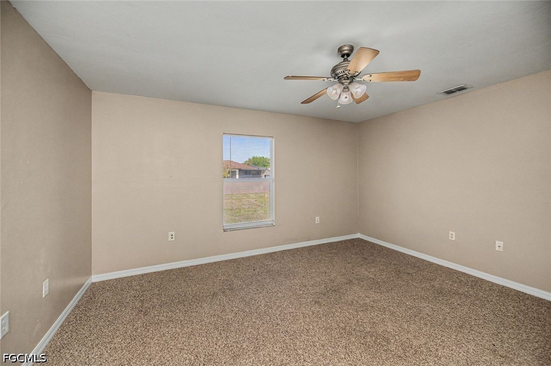 4104 13th Street Southwest Lehigh Acres, FL 33976 - Photo 26 of 46 an empty room with windows and ceiling fan