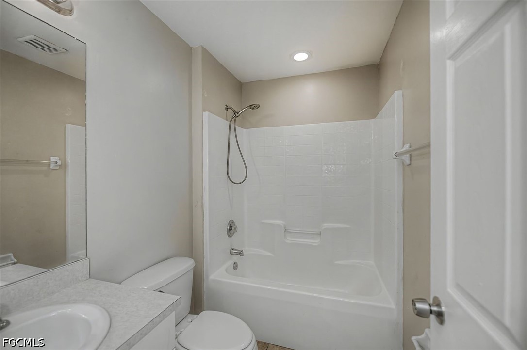 4104 13th Street Southwest Lehigh Acres, FL 33976 - Photo 30 of 46 a bathroom with a toilet and a shower