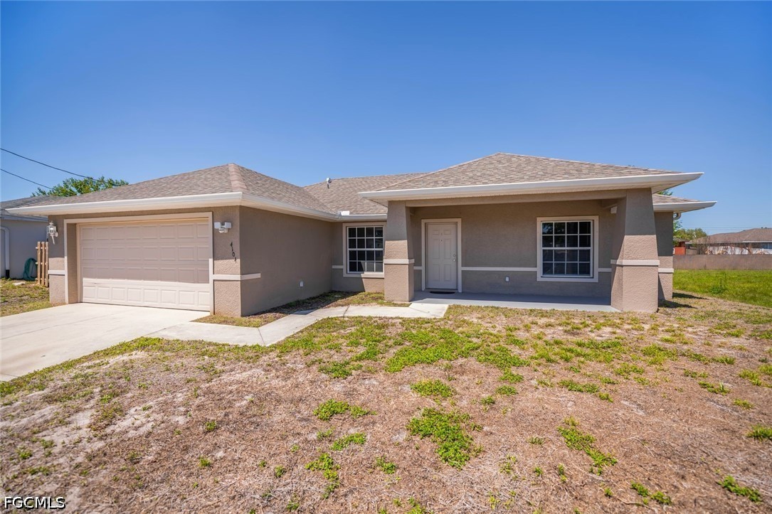 4104 13th Street Southwest Lehigh Acres, FL 33976 - Photo 39 of 46 a front view of a house with a yard