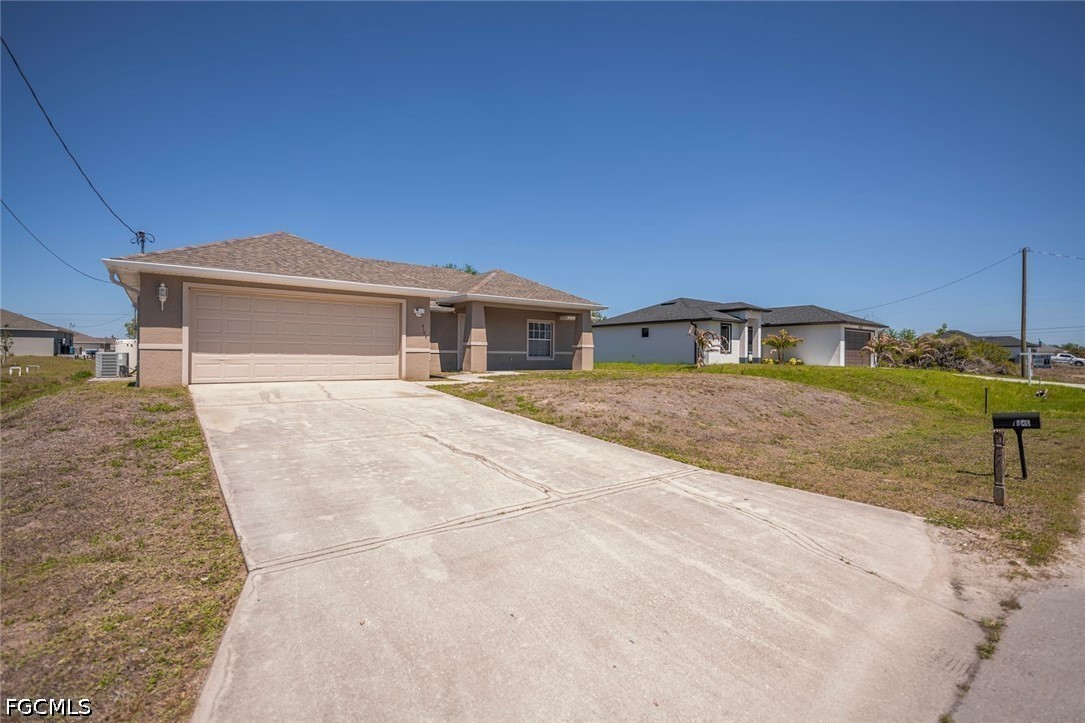 4104 13th Street Southwest Lehigh Acres, FL 33976 - Photo 40 of 46 a front view of a house with a yard