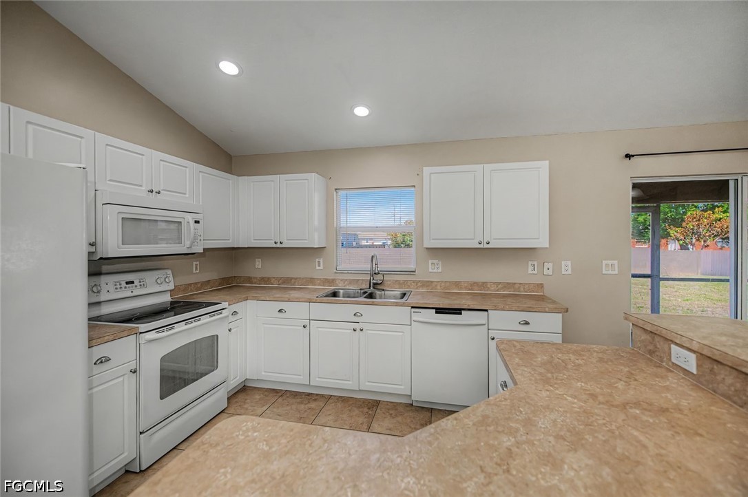 4104 13th Street Southwest Lehigh Acres, FL 33976 - Photo 4 of 46 a kitchen with stainless steel appliances granite countertop a stove sink and cabinets