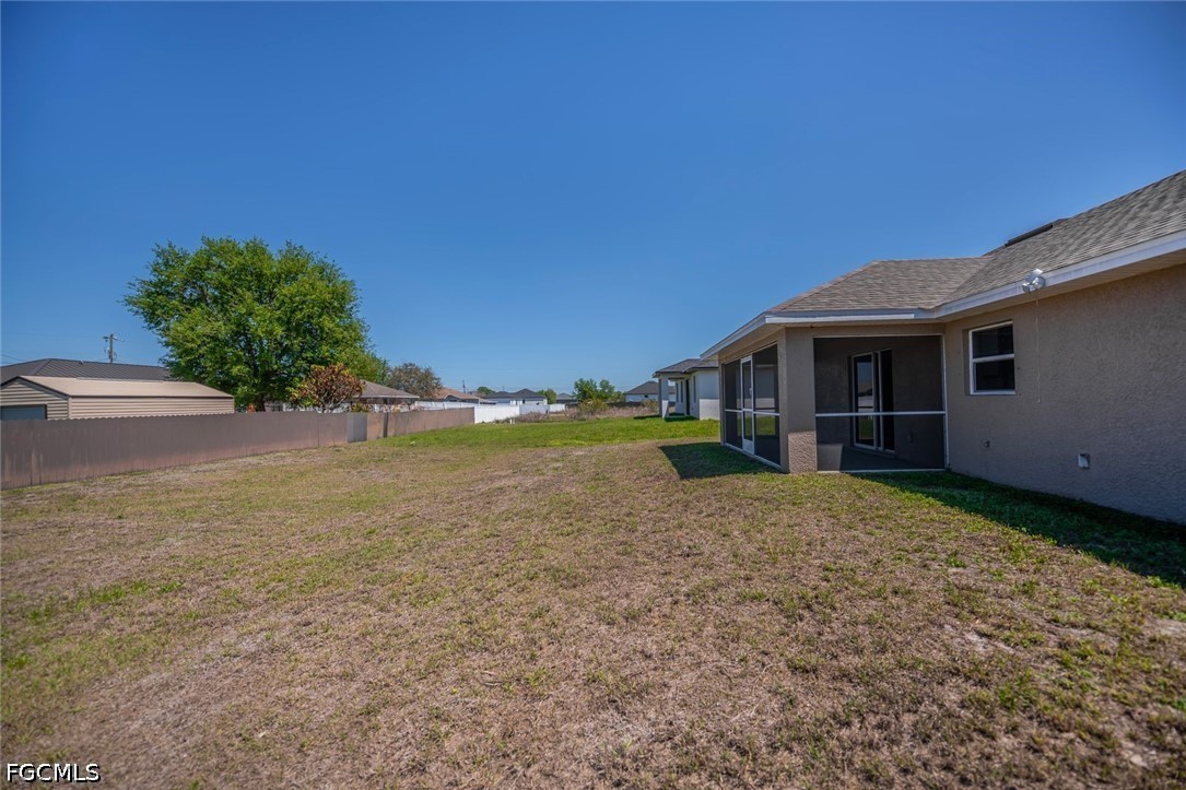4104 13th Street Southwest Lehigh Acres, FL 33976 - Photo 42 of 46 a view of a house with backyard and garden