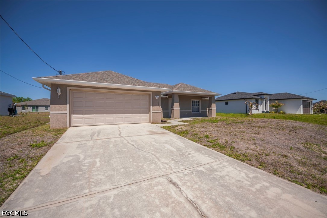 4104 13th Street Southwest Lehigh Acres, FL 33976 - Photo 43 of 46 front view of a house with a yard