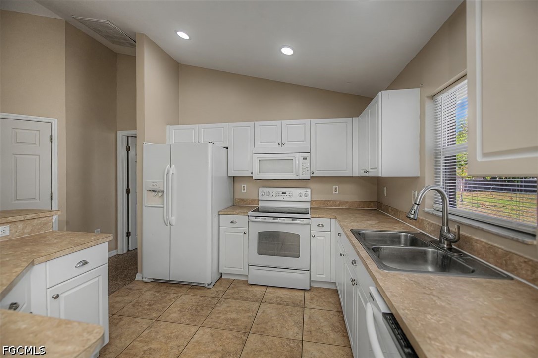 4104 13th Street Southwest Lehigh Acres, FL 33976 - Photo 5 of 46 a kitchen with a sink stove top oven and cabinets